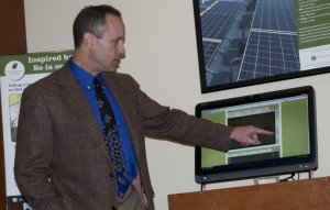 Marc Lopata demonstrates a touch screen display of solar energy production