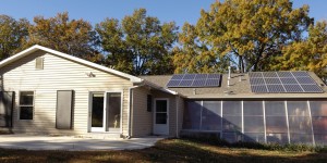 Home with solar panels and greenhouse