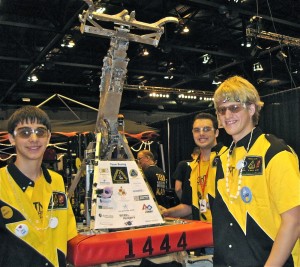 Members of the Lightning Lancers show off their robot